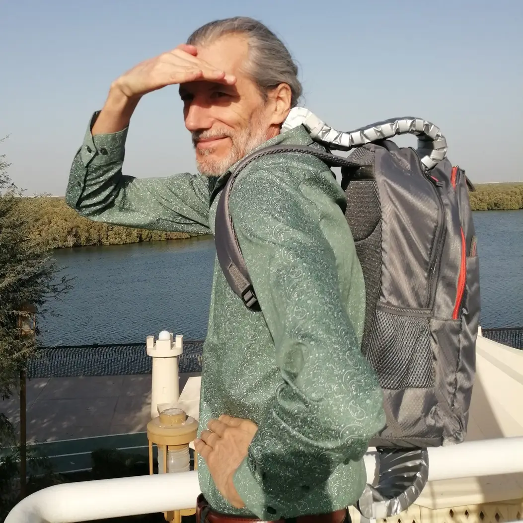 A person wearing the ComeBeCool cooling backpack - left profile